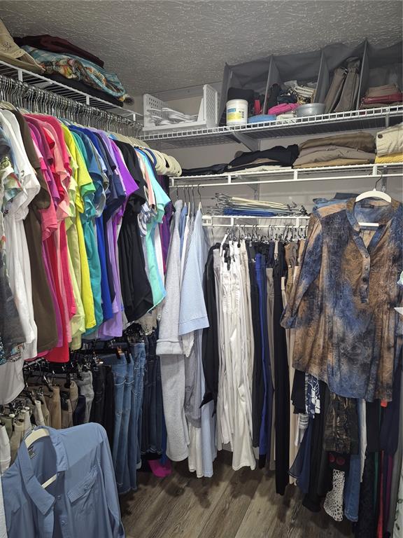 7614 Radcliffe Circle, Unit 104B Port Richey, FL 34668 - Photo 14 of 17 a view of walk in closet with clothes and shoes