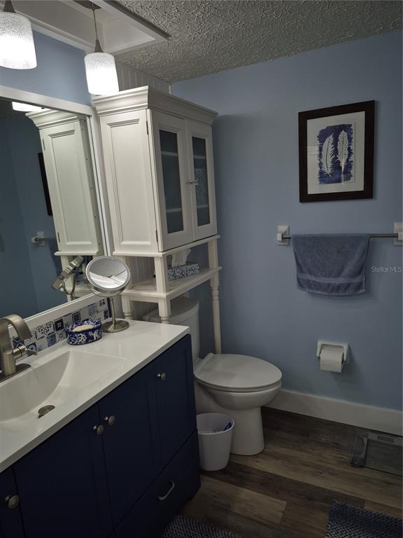 7614 Radcliffe Circle, Unit 104B Port Richey, FL 34668 - Photo 15 of 17 a bathroom with a sink toilet and a mirror