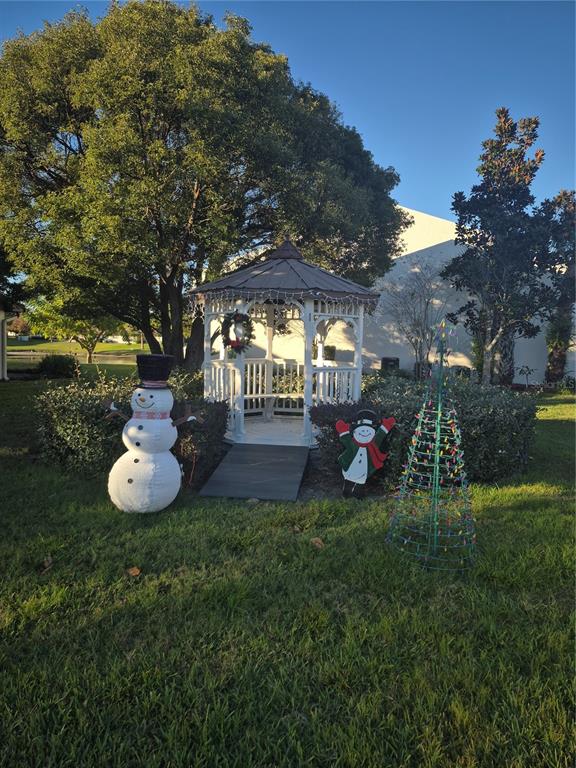 7614 Radcliffe Circle, Unit 104B Port Richey, FL 34668 - Photo 17 of 17 a view of a table and chairs in the garden