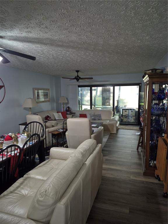 7614 Radcliffe Circle, Unit 104B Port Richey, FL 34668 - Photo 2 of 17 a living room with furniture and a large window