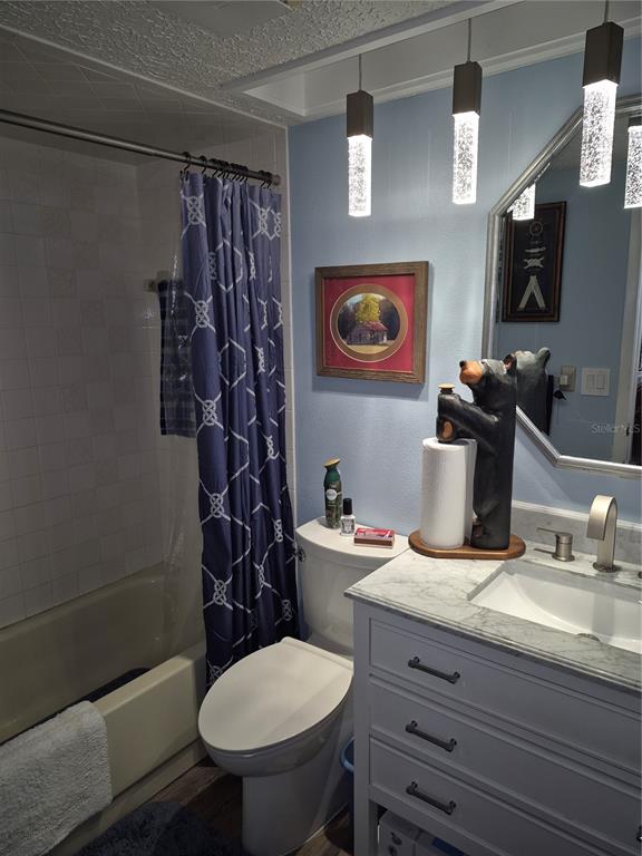 7614 Radcliffe Circle, Unit 104B Port Richey, FL 34668 - Photo 8 of 17 a bathroom with a toilet sink and mirror