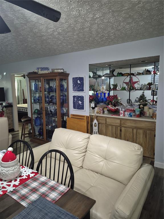 7614 Radcliffe Circle, Unit 104B Port Richey, FL 34668 - Photo 9 of 17 a living room with lots of furniture and white walls