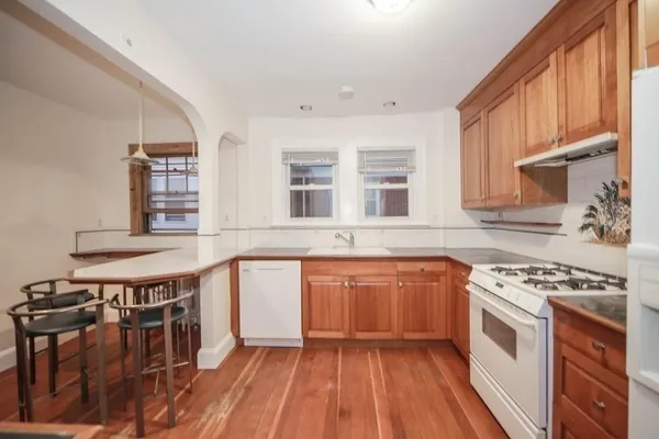 a kitchen with stainless steel appliances a stove a sink and a refrigerator