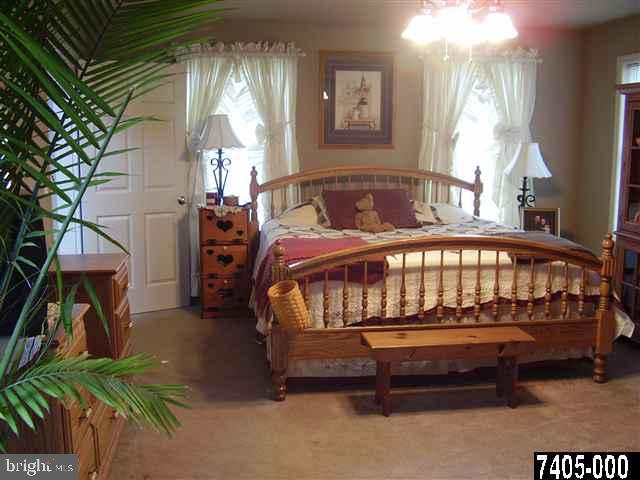 544 Rocky Ridge Road Spring Grove, PA 17362 - Photo 4 of 15 a bedroom with a bed and a chandelier