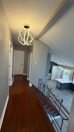 a bathroom with a granite countertop sink and a large mirror