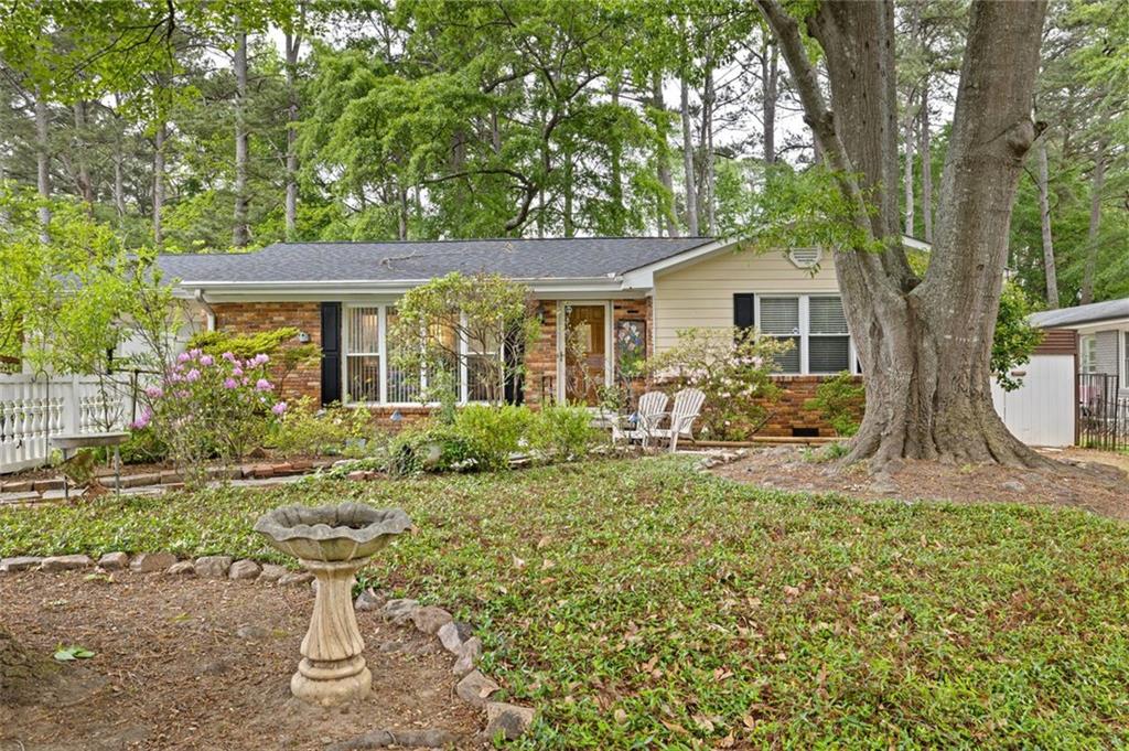 a view of a house with backyard sitting area and garden