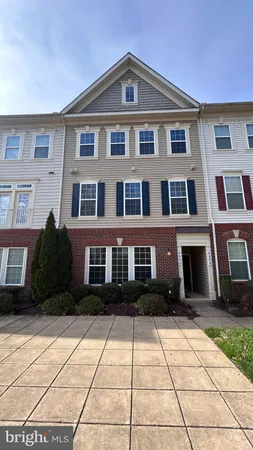 a front view of a brick house with many windows