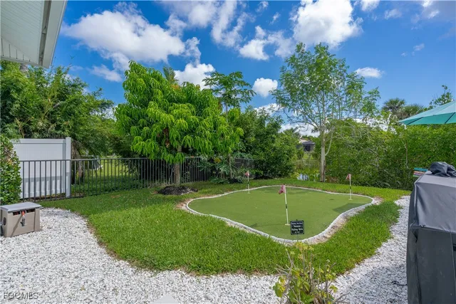 a view of a swimming pool with a patio and a yard