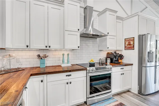 a kitchen with stainless steel appliances white cabinets and a sink