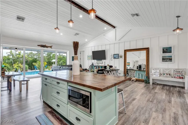 a kitchen with stainless steel appliances granite countertop a stove and a wooden floors