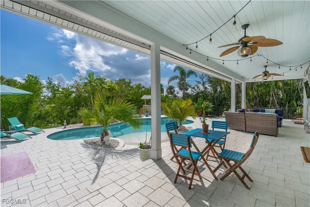 a view of a patio with a dining table and chairs