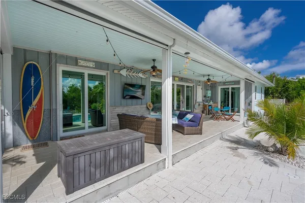 a view of a house with porch and furniture