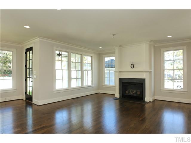 709 Wayne Drive Raleigh, NC 27608 - Photo 3 of 23 a view of an empty room with wooden floor and a window