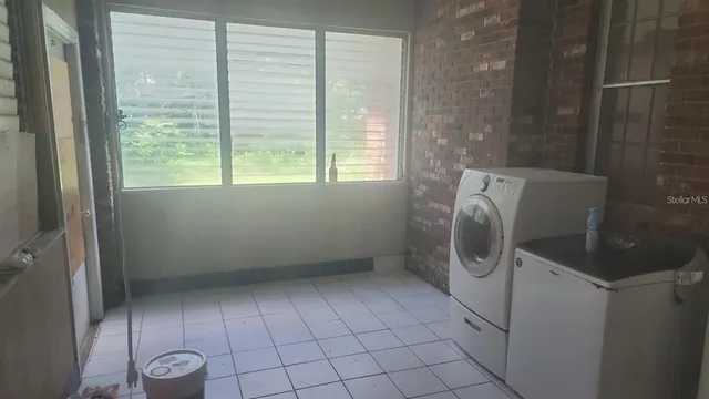 a view of storage and utility room with washer and dryer