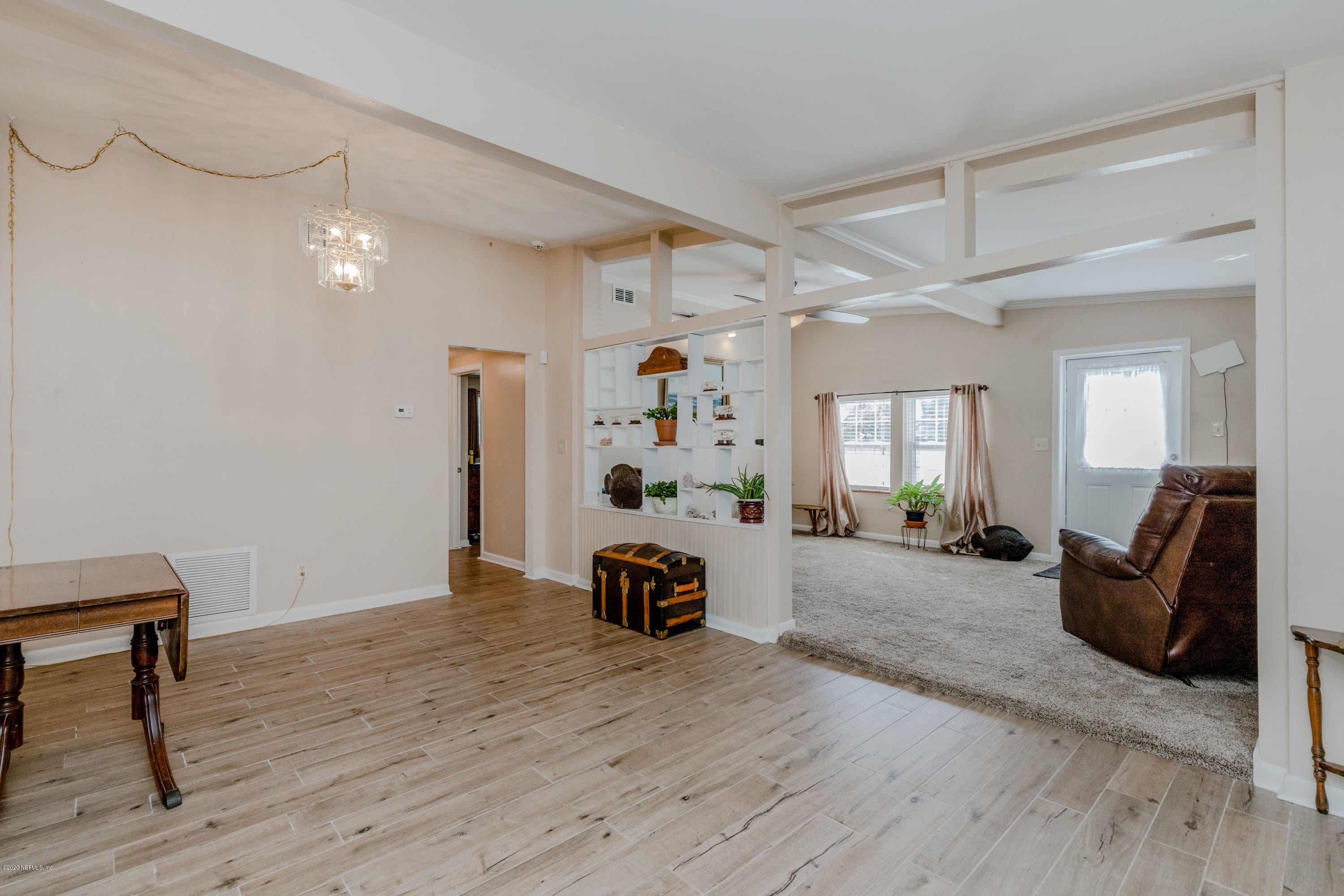 6921 Arques Road Jacksonville, FL 32205 - Photo 6 of 25 a living room with furniture and a chandelier
