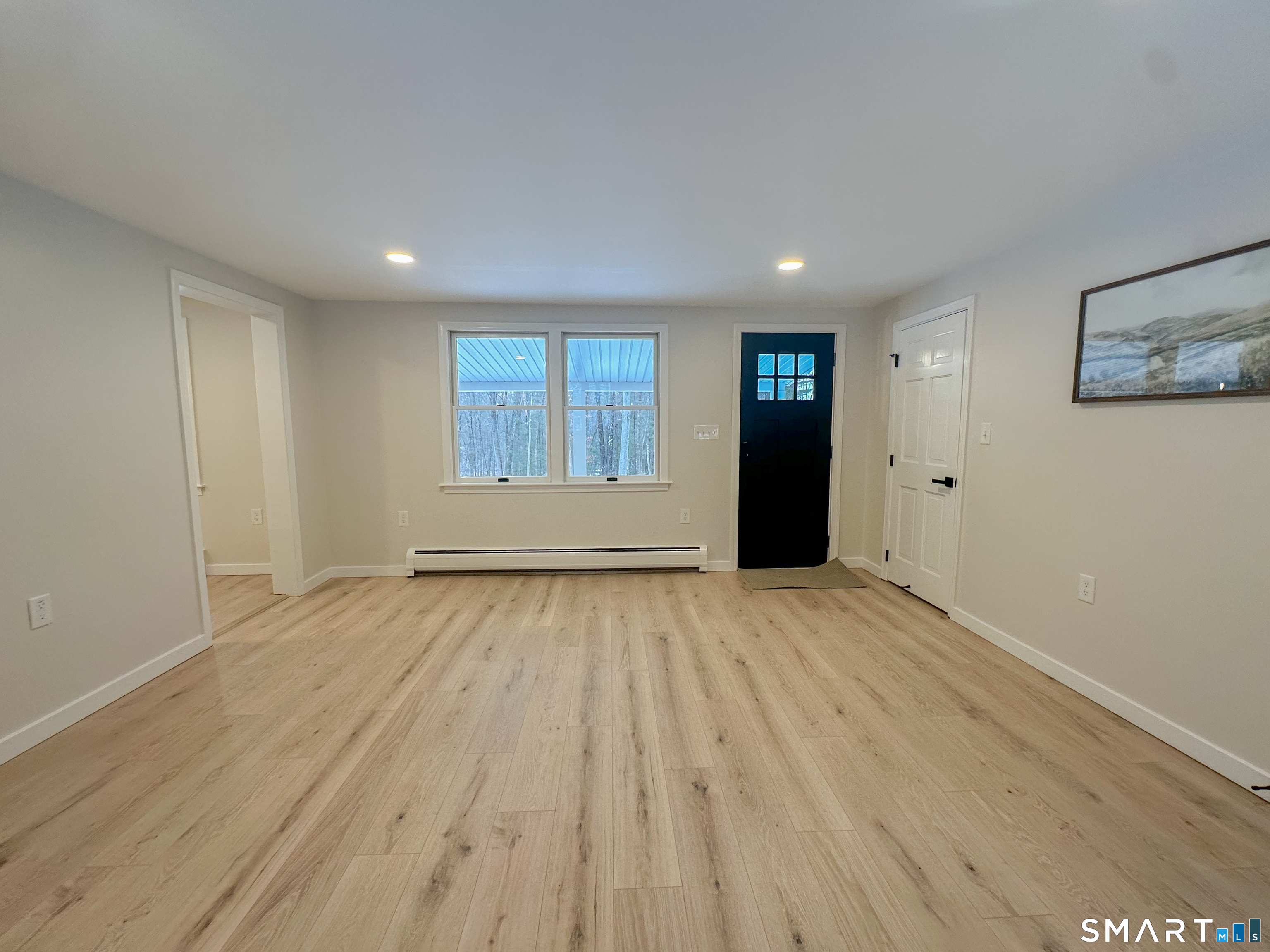92 Rose Haven Road Somers, CT 06071 - Photo 11 of 17 a view of an empty room with wooden floor and windows