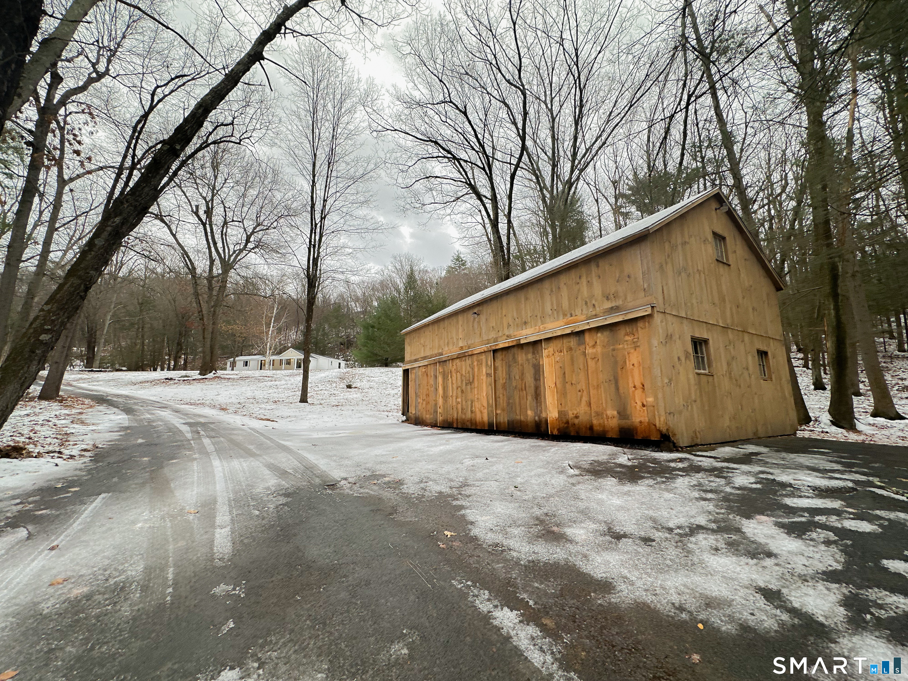 92 Rose Haven Road Somers, CT 06071 - Photo 3 of 17 a view of a house with snow on the road