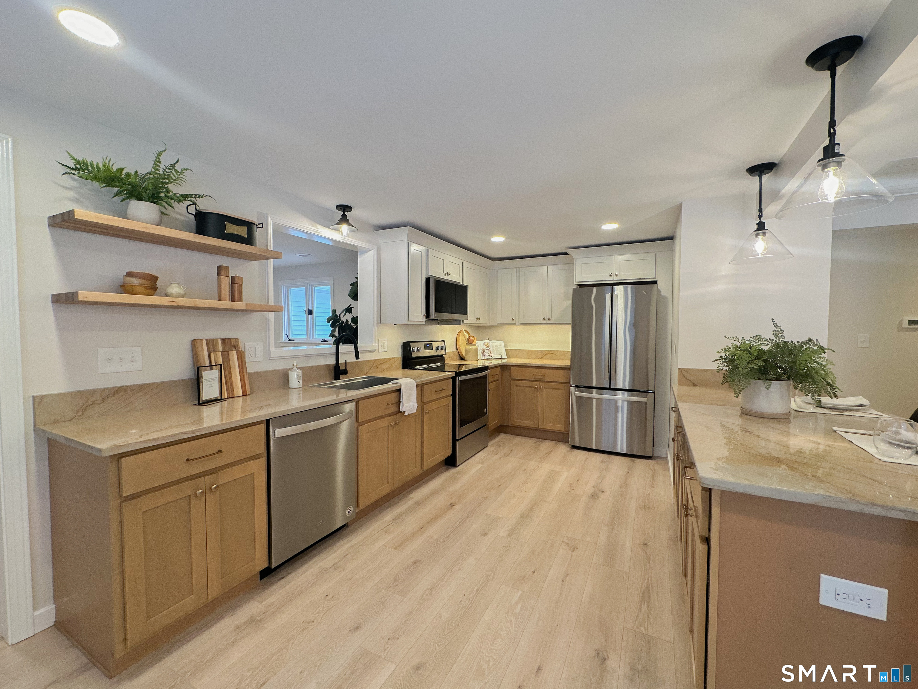 92 Rose Haven Road Somers, CT 06071 - Photo 6 of 17 a kitchen with a sink stainless steel appliances and white cabinets