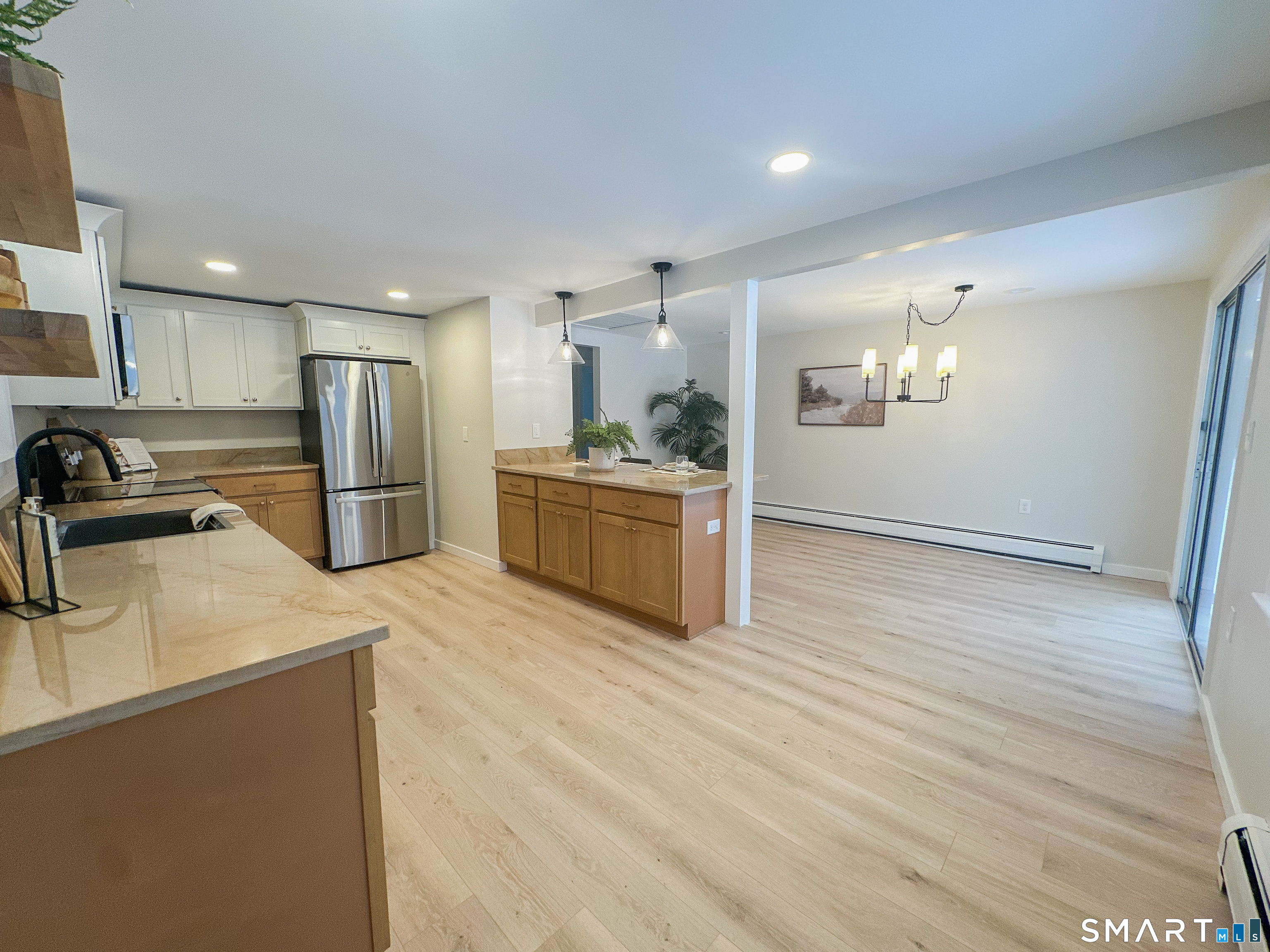 92 Rose Haven Road Somers, CT 06071 - Photo 7 of 17 a kitchen with stainless steel appliances a refrigerator sink and wooden cabinets
