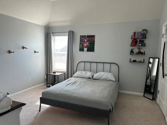 a bedroom with a bed and a window