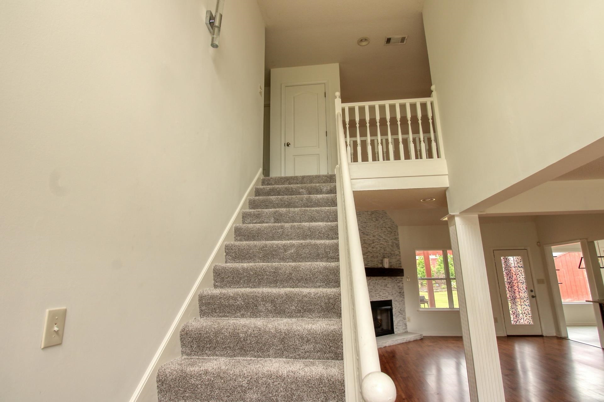 25 Whispering Ridge Cove Oakland, TN 38060 - Photo 14 of 19 Carpeted staircase with white balusters leading to an upper landing