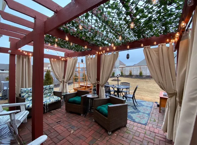 a outdoor living space with patio furniture and a large window