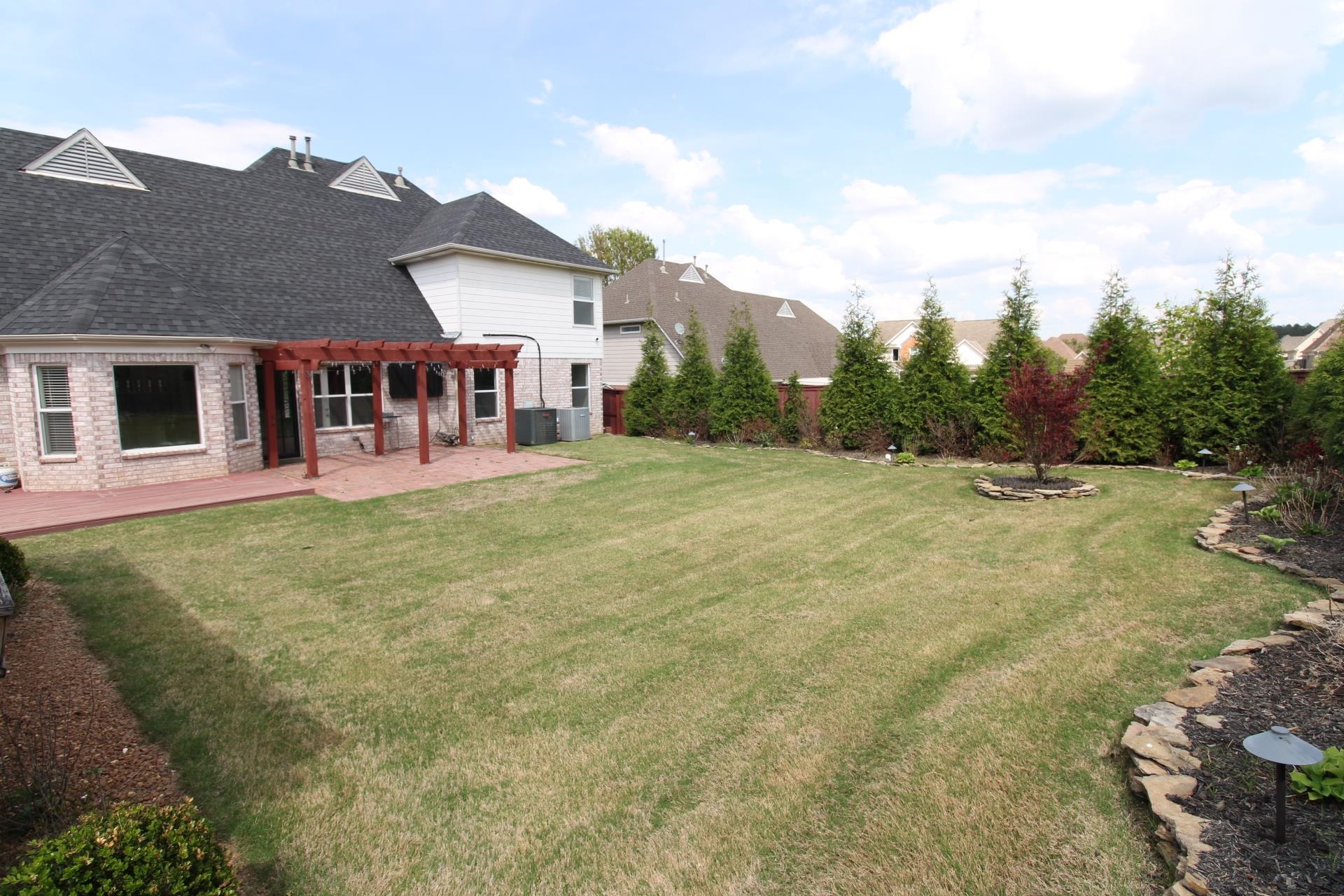 25 Whispering Ridge Cove Oakland, TN 38060 - Photo 18 of 19 Expansive green lawn with mature evergreen trees bordering the property