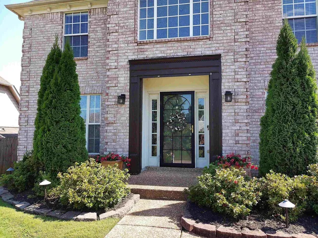 a front view of a house with garden