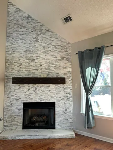 a front view of a fireplace with window