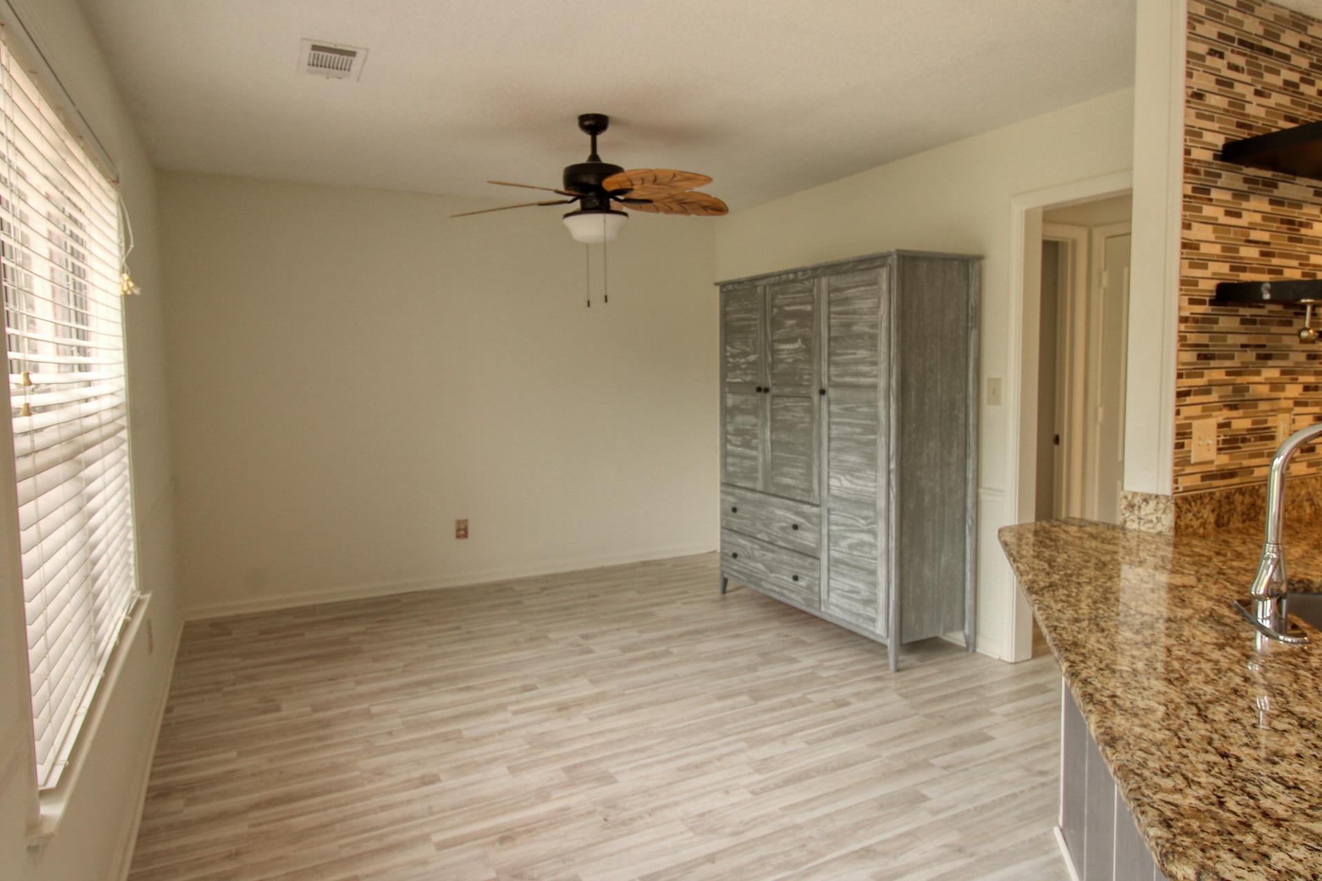 25 Whispering Ridge Cove Oakland, TN 38060 - Photo 8 of 19 Light wood-finish flooring complements the neutral wall color in this versatile room