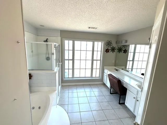 a bathroom with a bathtub and a shower