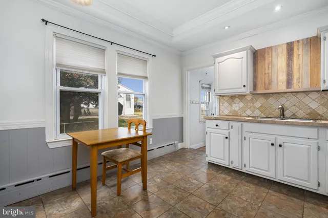 a room with granite countertop cabinets and window