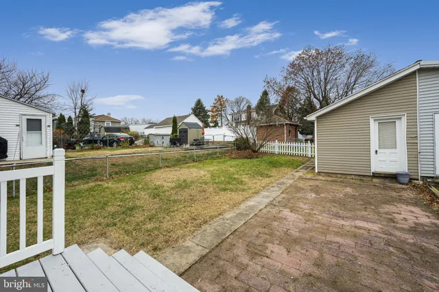 a view of a patio with table and chairs with wooden floor and fence