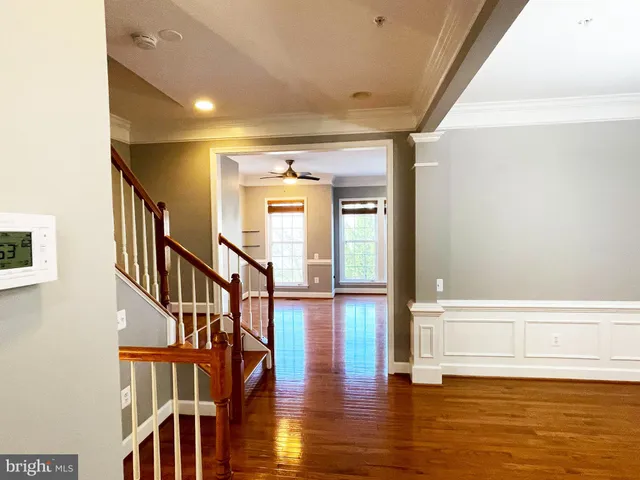 a view of staircase with wooden floor and a rug