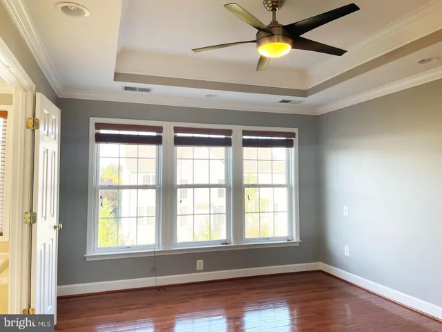 an empty room with window and lamp