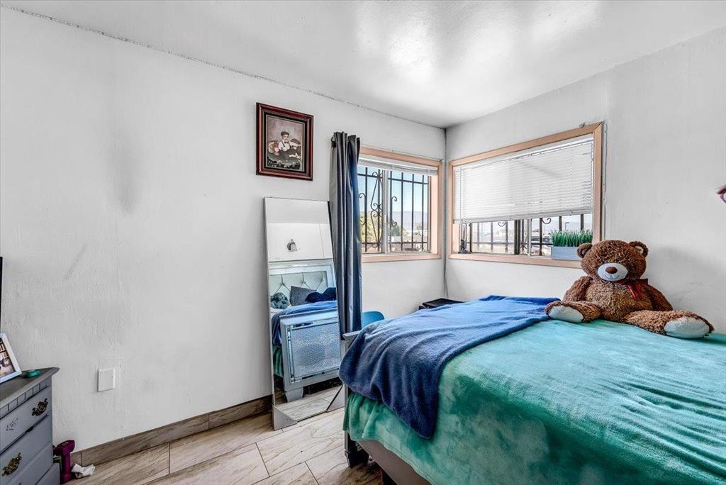 112 Serrano Place Soledad, CA 93960 - Photo 11 of 19 a bedroom with a bed and wooden floor