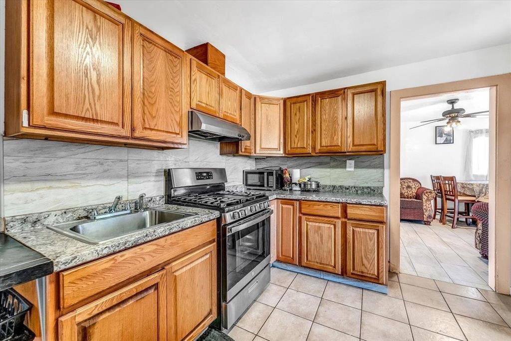 112 Serrano Place Soledad, CA 93960 - Photo 9 of 19 a kitchen with stainless steel appliances granite countertop a stove a sink and a microwave