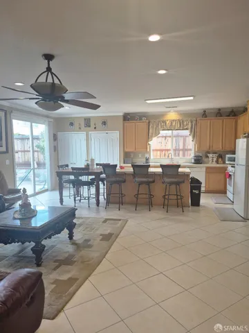 a dining hall with stainless steel appliances a dining table and chairs