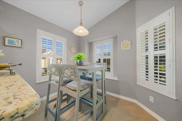 a view of a dining room with furniture and a window