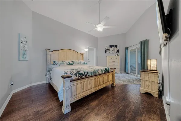 a bedroom with a bed window and a flat screen tv
