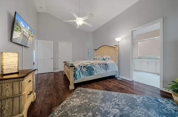a bedroom with a bed and a chandelier