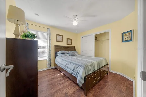 a bedroom with a bed chandelier and a window