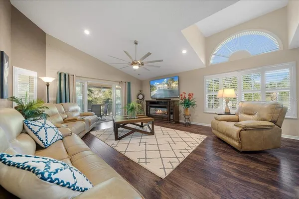a living room with furniture fireplace and a large window