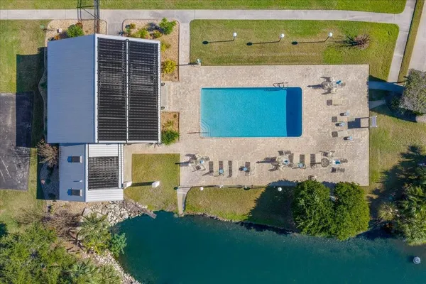 an aerial view of a house with a garden and lake view