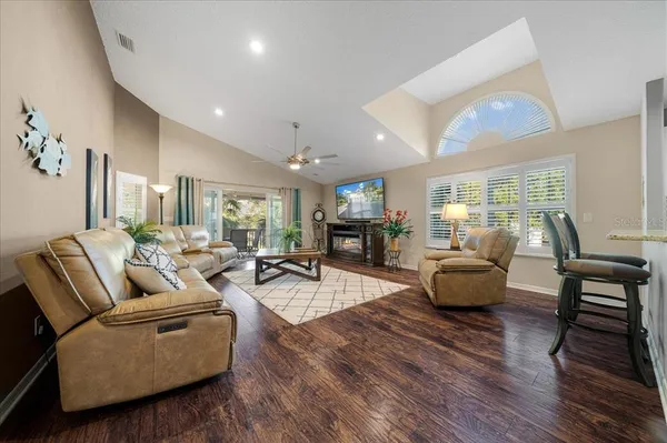 a living room with fireplace furniture and a wooden floor
