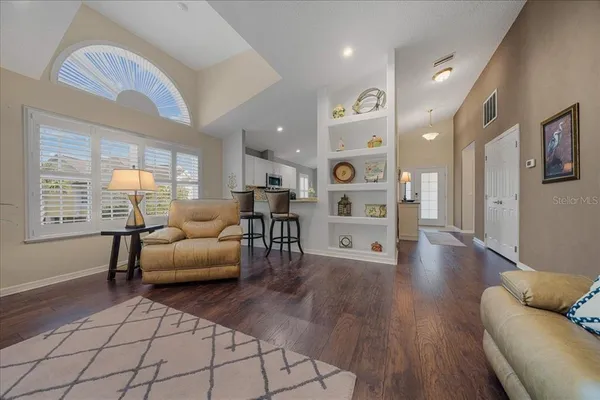 a living room with furniture and kitchen view