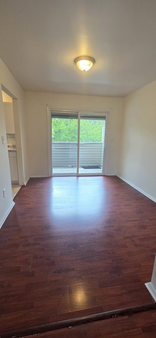 2001 South Mattis Avenue, Unit E Champaign, IL 61821 - Photo 3 of 11 an empty room with wooden floor and windows