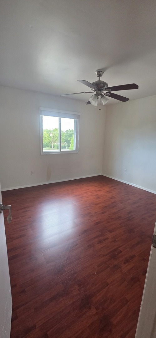 2001 South Mattis Avenue, Unit E Champaign, IL 61821 - Photo 7 of 11 an empty room with a window and a ceiling fan