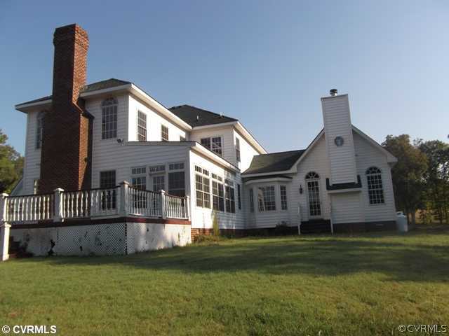 1661 Huntingdon Road Crozier, VA 23039 - Photo 2 of 5 a front view of a house with a garden and yard