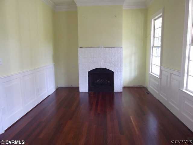 1661 Huntingdon Road Crozier, VA 23039 - Photo 3 of 5 a view of an empty room with wooden floor and a window
